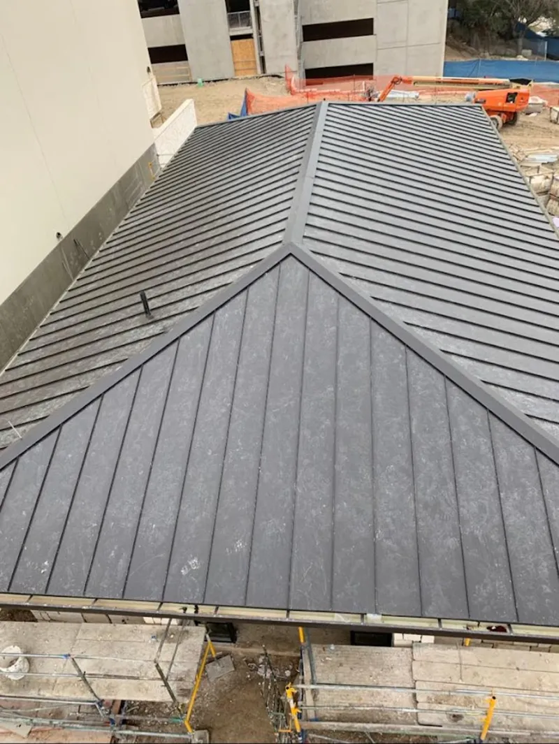 Commercial metal roof construction with crane equipment in South Union